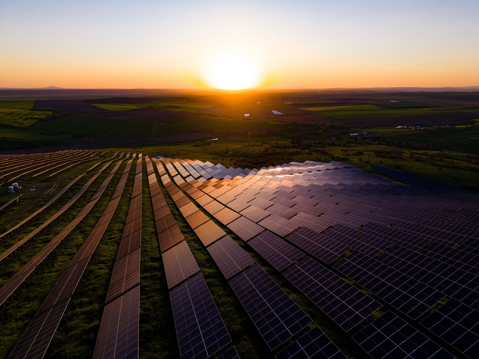 Utility-scale solar plant at golden hour, monitored and protected by Oppus-integrated systems.